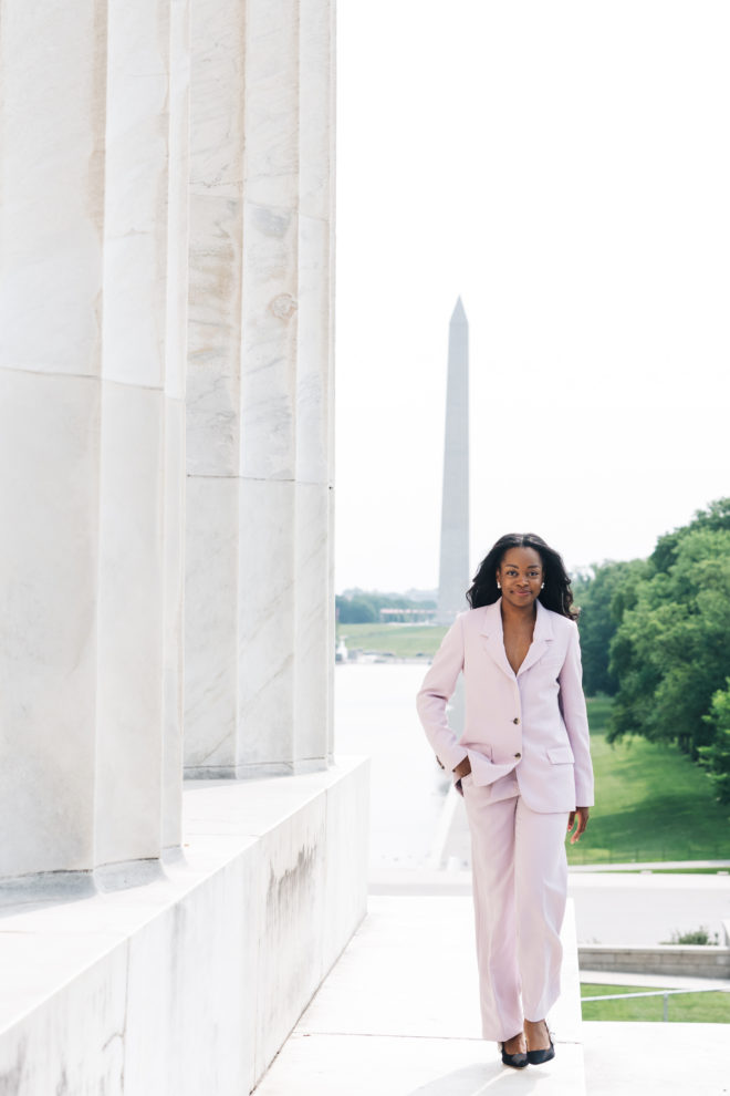 Photo of Michelle Aninye walking in front of the Washington Monument